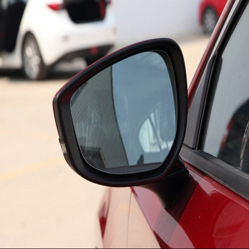 Car side mirror with a blurred background of other vehicles