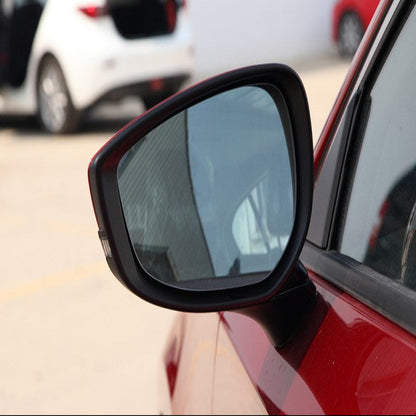 Car side mirror with a blurred background of other vehicles