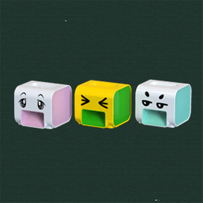 Three colorful rectangular objects with cartoon faces on a dark green background