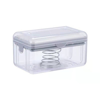 Clear plastic container with a spring inside on a white background