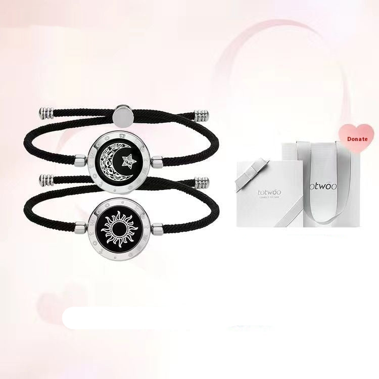 Sun and moon design bracelets on black ropes with a boutique gift box.