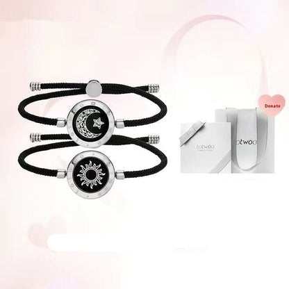 Sun and moon design bracelets on black ropes with a boutique gift box.