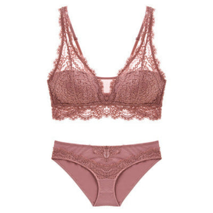 Pink lace bra and panties set on a white background