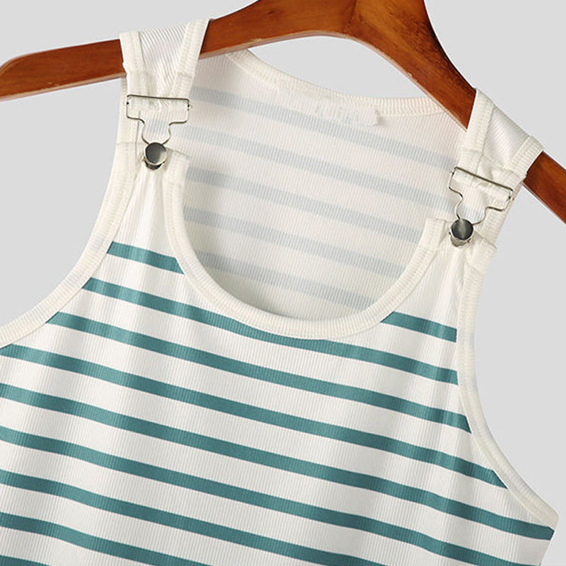 Striped dress with suspenders on a hanger against a gray background