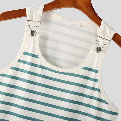 Striped dress with suspenders on a hanger against a gray background