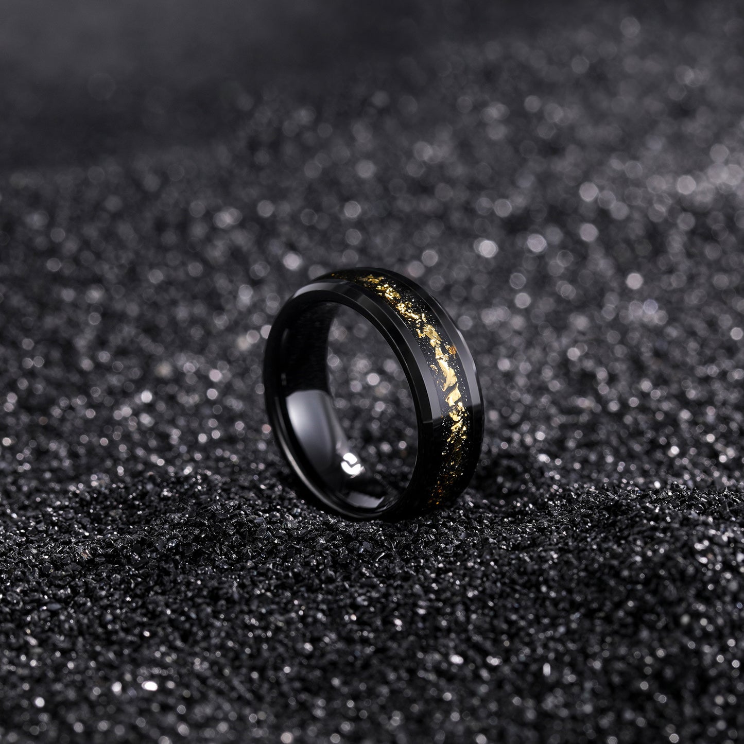 Black ring with gold accents on a black textured background