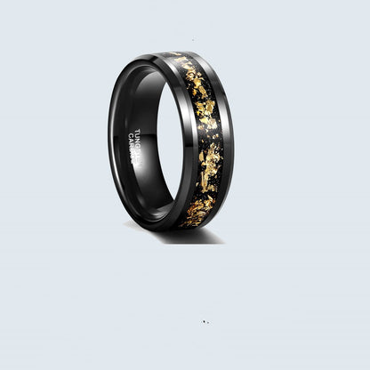 Black tungsten ring with gold inlay on a light gray background