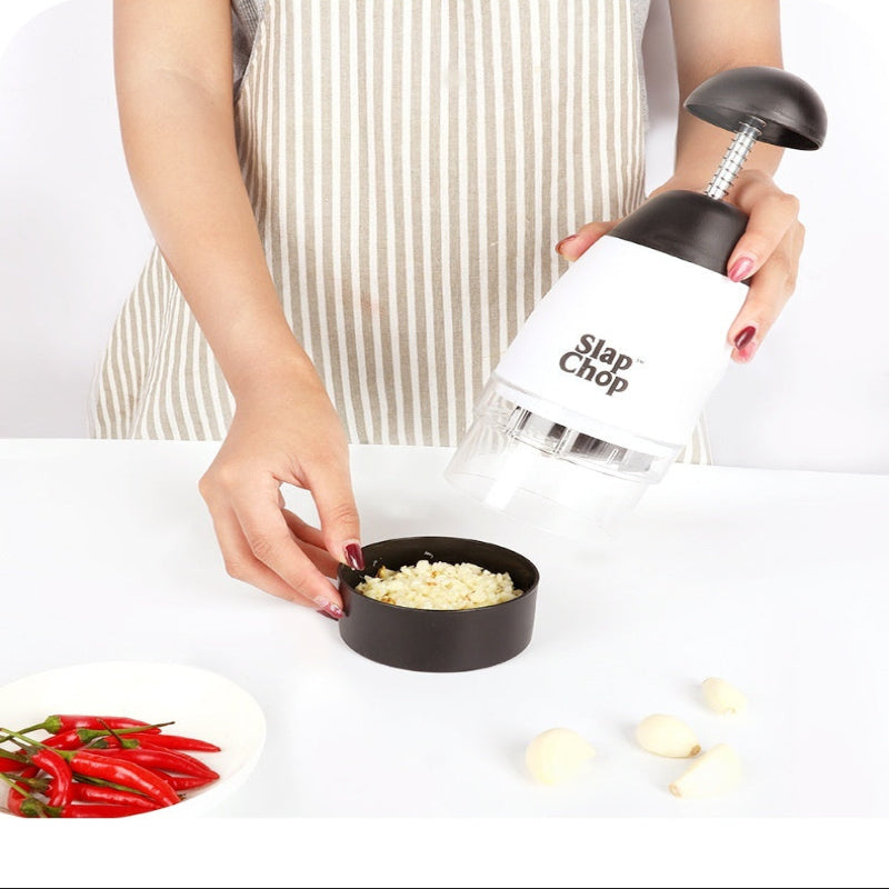 Person using a Slap Chop kitchen gadget to shred vegetables with text highlighting its ease and labor-saving benefits.
