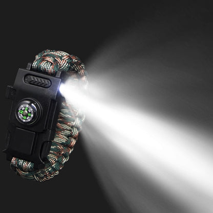 Paracord bracelet with flashlight and compass on a dark background
