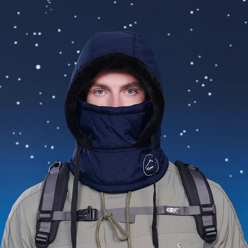 Person wearing a dark blue hood and balaclava with a backpack against a starry night sky.