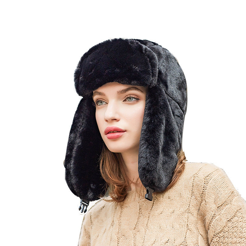 Woman wearing a black and gray fur-trimmed hat on a white background