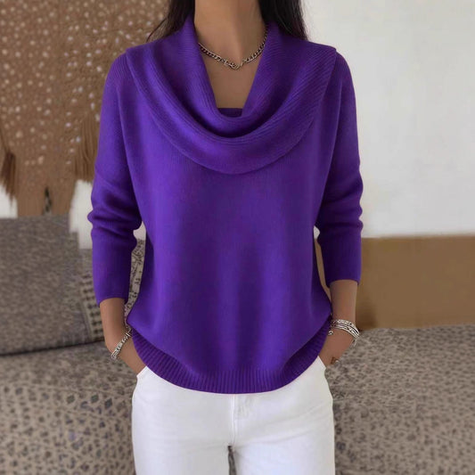 Person wearing a purple cowl-neck sweater with a neutral background