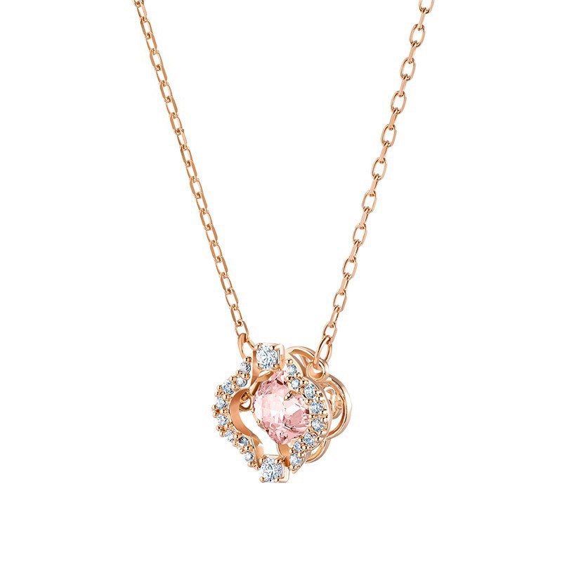 Rose gold necklace with a pink gemstone pendant on a white background