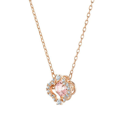 Rose gold necklace with a pink gemstone pendant on a white background
