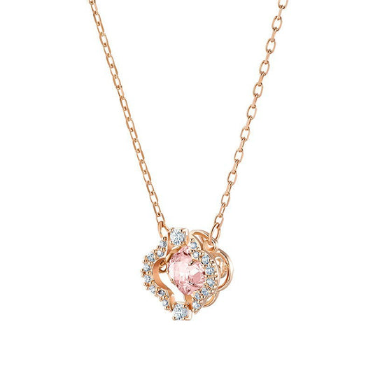 Rose gold necklace with a pink gemstone pendant on a white background
