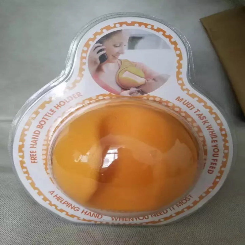 Orange baby bottle holder with packaging on a gray surface