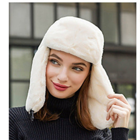 Woman wearing a white fur-trimmed winter hat with a blurred background
