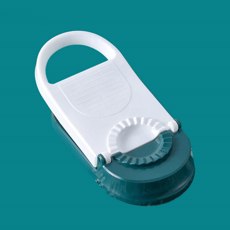 White and green kitchen tool on a teal background