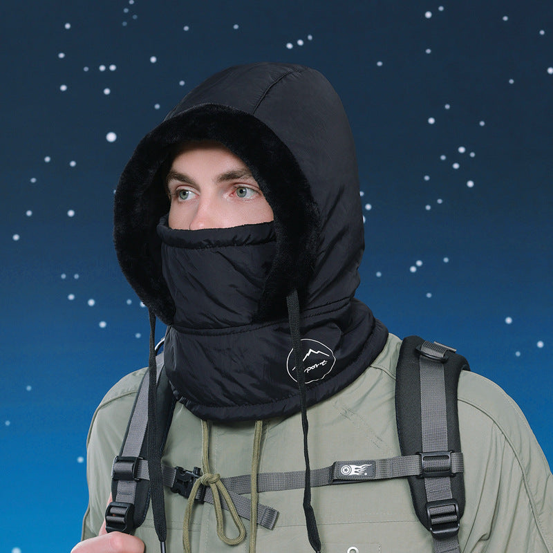 Person wearing a black hooded balaclava with a starry night sky background