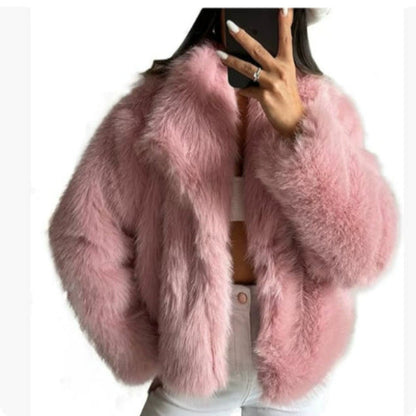 Pink fluffy jacket worn by a person on a white background