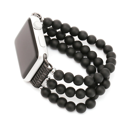 Smartwatch with a black beaded bracelet on a white background