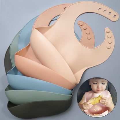 Set of silicone bibs in various colors with a child holding a yellow object inset.