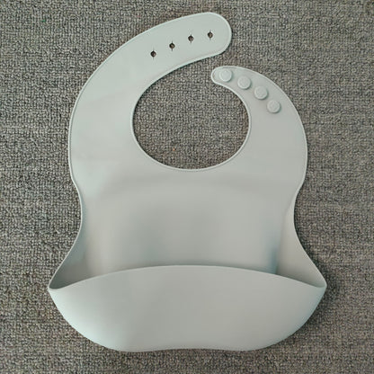 Gray silicone bib on a textured gray surface