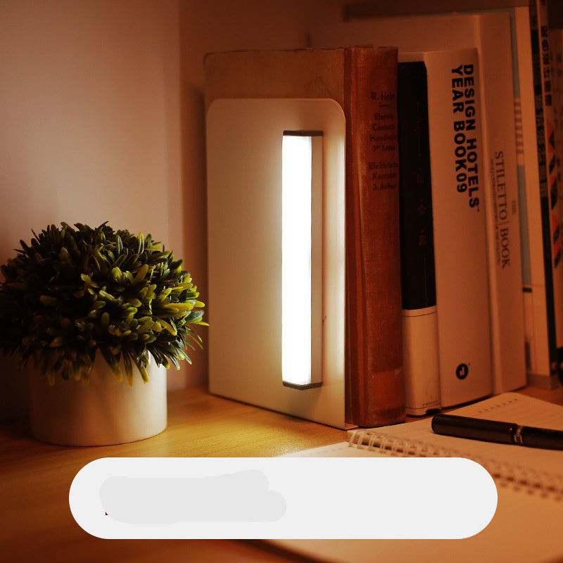 Desk with books, a plant, and a light source with a '150mm' label.