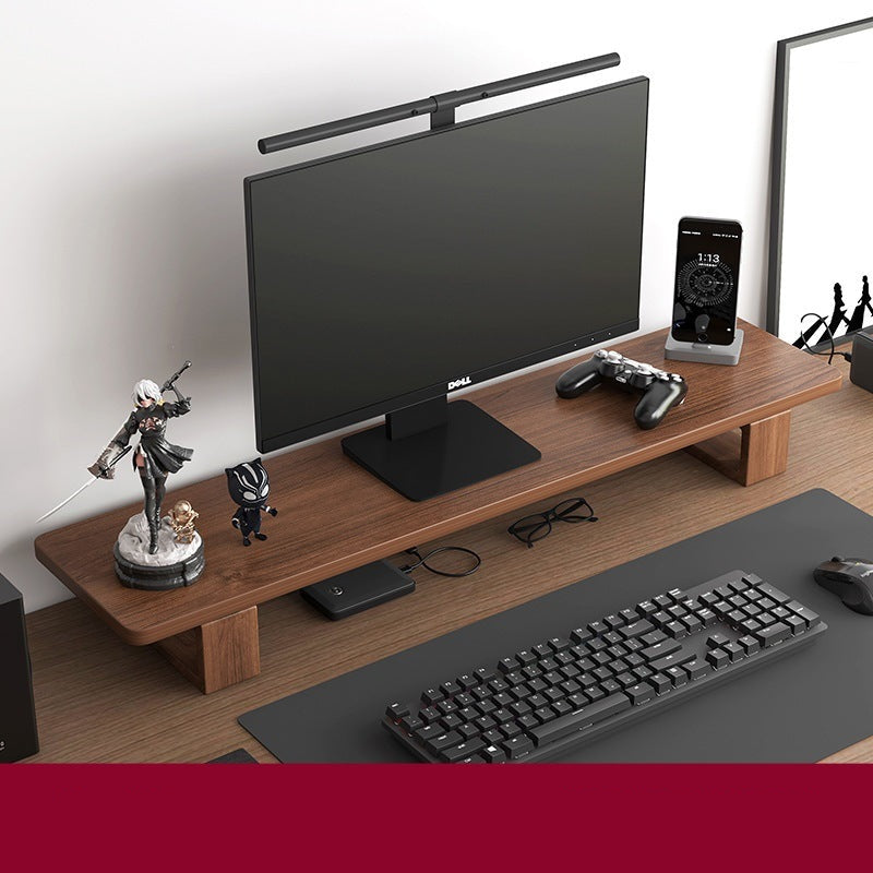 Monitor stand made of black walnut wood, with a computer monitor, keyboard, and various desk accessories on it, placed on a wooden floor against a white background.