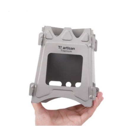 Hand holding a gray metal stand with 'TF Artisan Titanium' branding on a white background