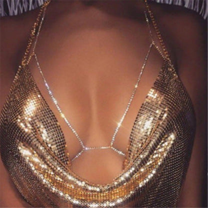 A close-up image of a shining golden rhinestone halter necklace designed to be worn as body chain jewelry.