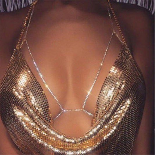 A close-up image of a shining golden rhinestone halter necklace designed to be worn as body chain jewelry.