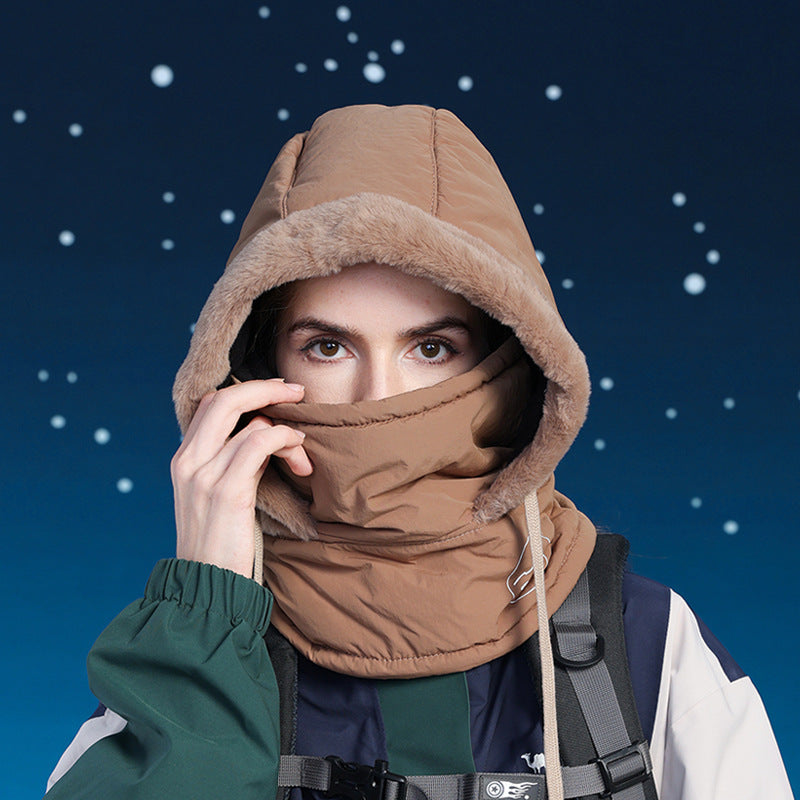 Person wearing a brown hooded jacket against a starry night sky