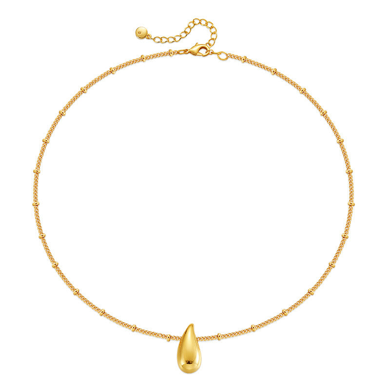 Gold necklace with a teardrop-shaped pendant on a white background