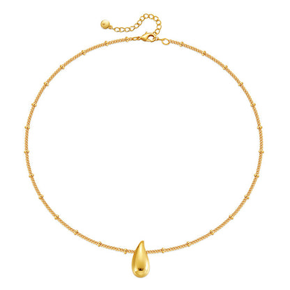 Gold necklace with a teardrop-shaped pendant on a white background