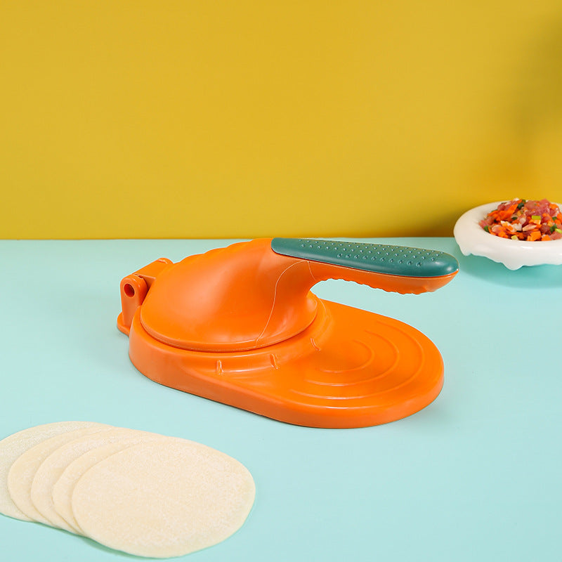 Orange pizza cutter on a blue surface with yellow background