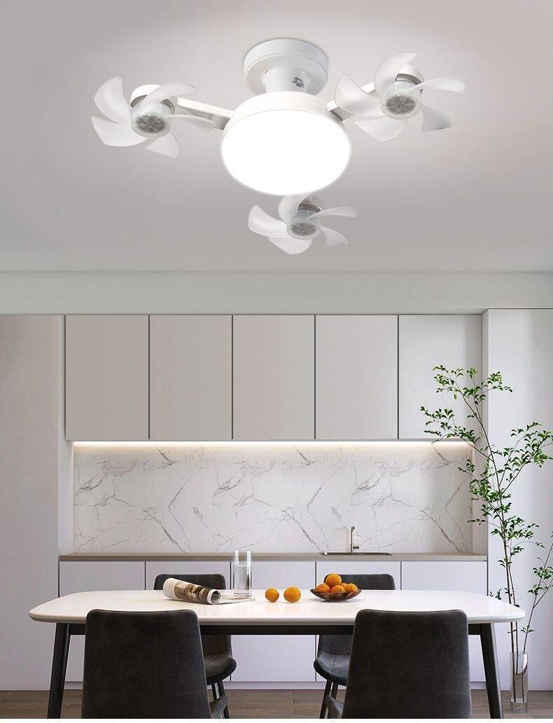 Modern kitchen with a ceiling fan, white marble backsplash, and a dining table.
