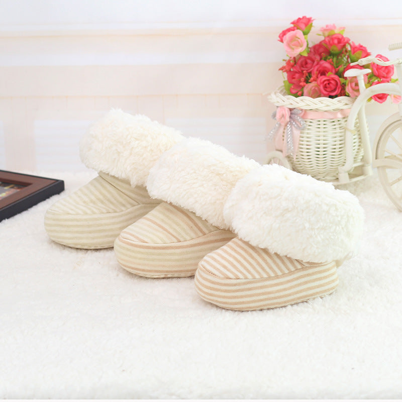 Pair of white slippers on a soft surface with a decorative background