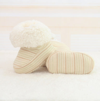 Three cream-colored pillows on a light beige background