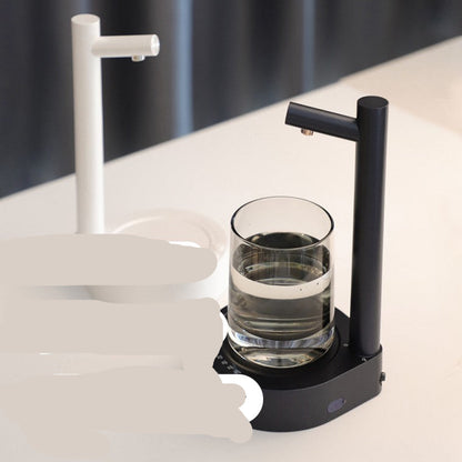 Smart table water dispenser with a glass of water on a white surface
