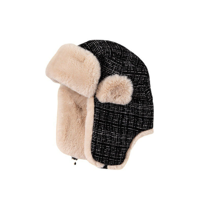 Black textured winter hat with beige fur trim on a white background
