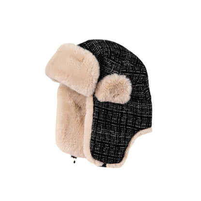 Black textured winter hat with beige fur trim on a white background