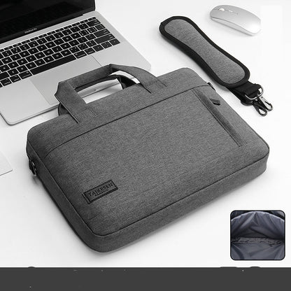 Black laptop bag with a handle and zipper closure, displayed next to a laptop and a mouse, with an inset showing the interior of the bag.
