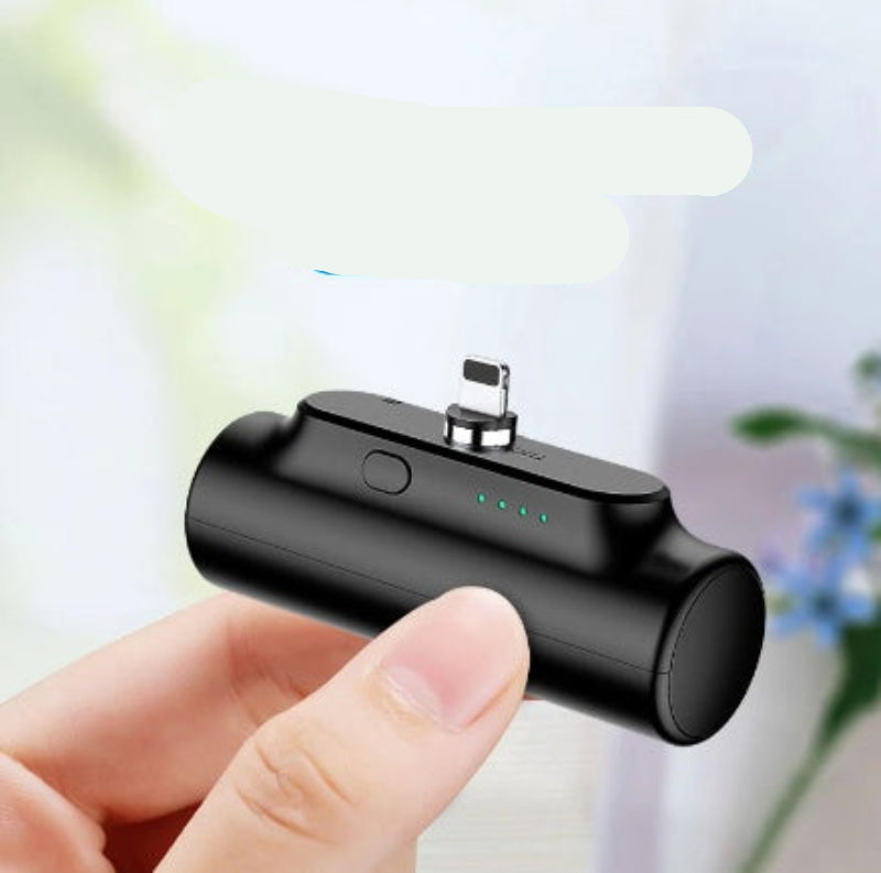 Small black device held in a hand with text indicating its weight