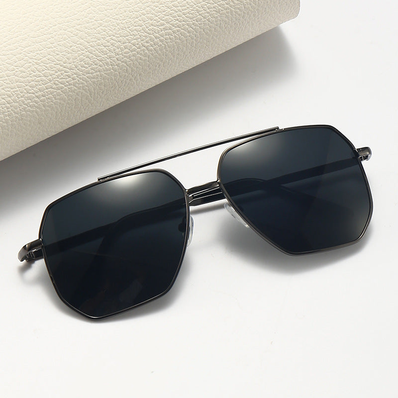 A pair of aviator style sunglasses with a double beam design, featuring dark lenses and a metallic frame.