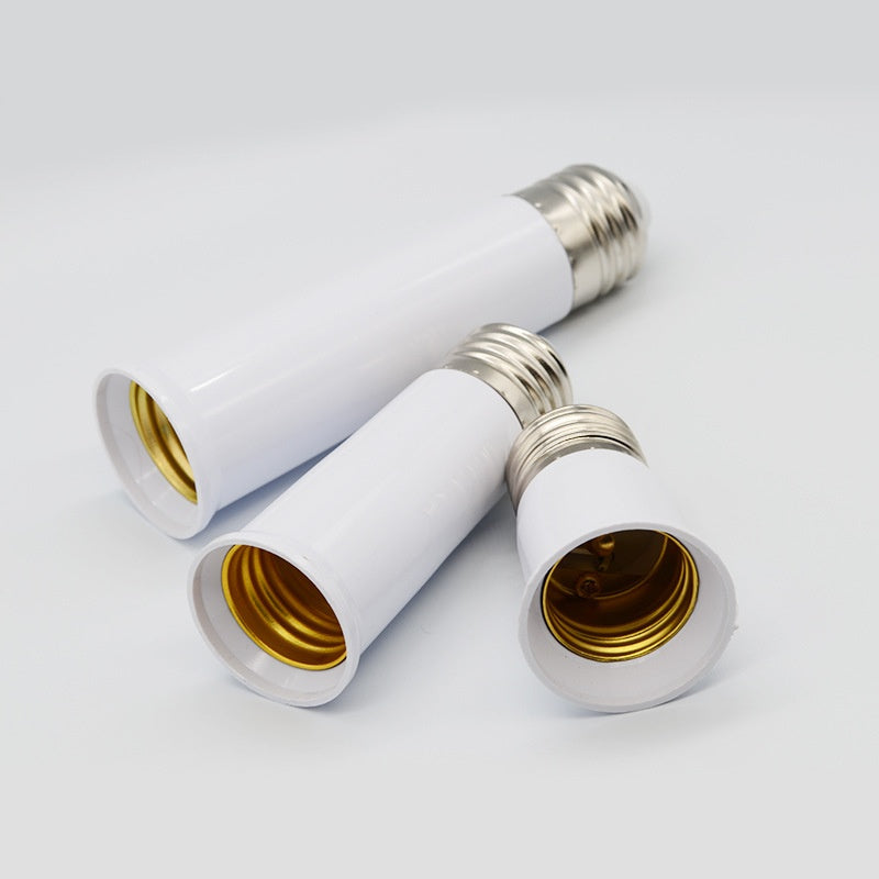 Two white light bulb adaptors on a light gray background