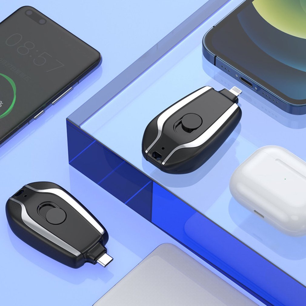 Two black and silver USB drives on a blue surface with smartphone and mouse in the background