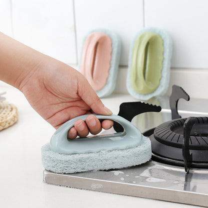 Hand holding a blue scrubber over a stove with other scrubbers in the background.