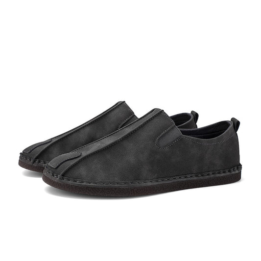 Pair of black slip-on shoes on a white background