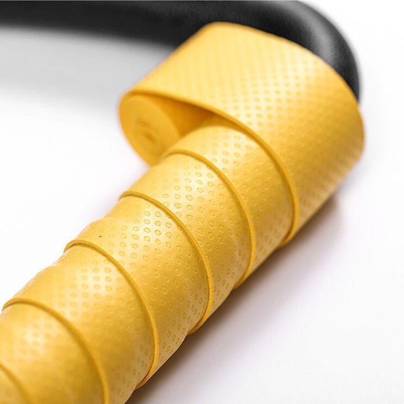 Close-up of a yellow resistance band on a white background